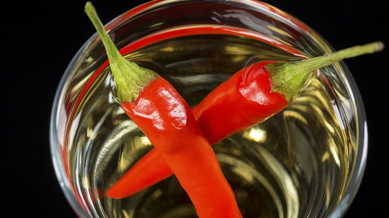 chili peppers in tequila glass